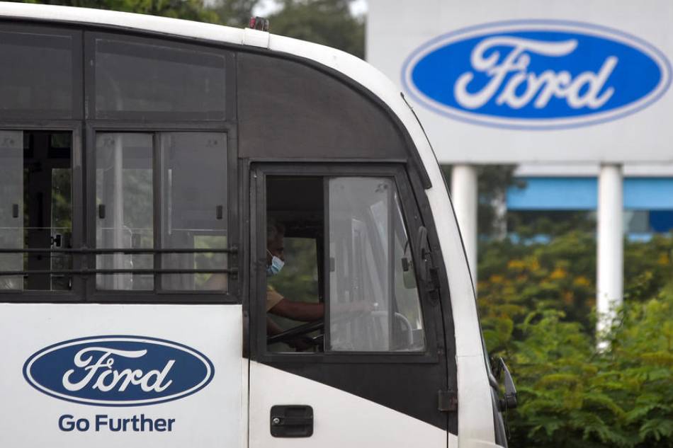 A man drives a bus in front of the Ford logo at the Ford India plant located in Chengalpattu, some 50km south of Chennai, India, 13 September 2021. EPA-EFE/IDREES MOHAMMED/FILE
