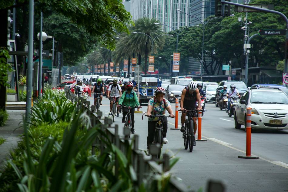 Cyclists share the road with motorists in Makati’s central business district on Aug. 8, 2022. The Philippines' financial hub is looking at the scientific data of its impact on climate change and declared a state of climate emergency to address on the ground, and is studying how policies that it will adopt will help address rising temperatures. Jonathan Cellona, ABS-CBN News