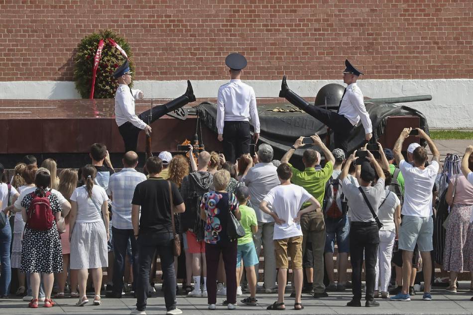 Russian tourists watch honor guard soldiers marching in front of the Tomb of the Unknown Soldier by the Kremlin Wall in Moscow, Russia 05 August 2022 (issued 09 August 2022). EPA-EFE/MAXIM SHIPENKOV