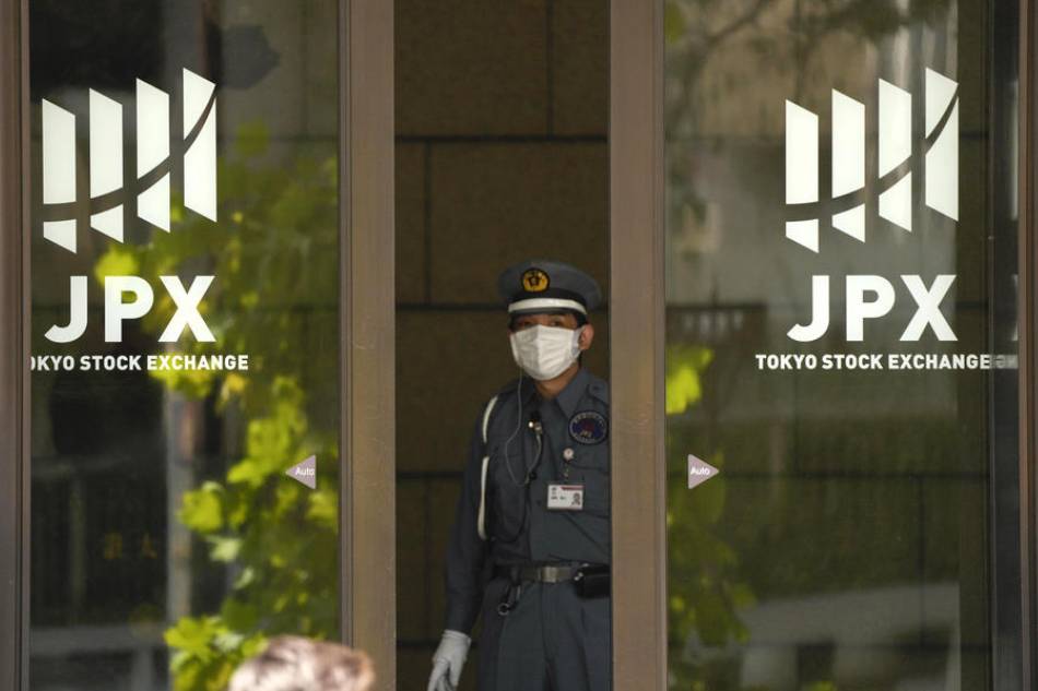 A member of security personnel looks out the door of the Tokyo Stock Exchange, in Tokyo, Japan, 14 September 2022. The Dow Jones Industrial Average in the US plunged over 1,200 points on 13 September. The Tokyo stock benchmark fell more than 800 points in the morning trading session on 14 September. EPA-EFE/KIMIMASA MAYAMA EPA-EFE/KIMIMASA MAYAMA