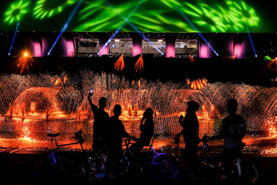 Park goers watch the lights and sounds show, SINAG 2022 at the Cultural Center of the Philippines (CCP) in Pasay City on Sept. 23, 2022. George Calvelo, ABS-CBN News