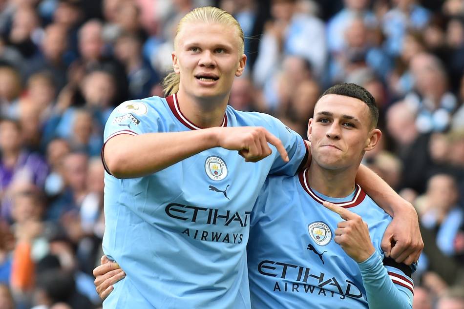 Phil Foden (R) of Manchester City celebrates with Erling Haaland (L) after scoring a hat-trick in the English Premier League soccer match between Manchester City and Manchester United at Etihad Stadium in Manchester, Britain, 02 October 2022. Peter Powell, EPA-EFE.