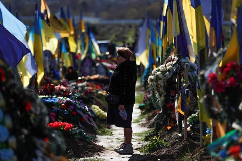A relative of a fallen soldier visits his grave at the military graveyard in the city of Kharkiv, Ukraine, Oct. 14, 2022 amid the Russian invasion. Ukrainians mark Defenders of Ukraine Day annually on this day since 2015. Russian troops entered Ukraine on Feb. 24, 2022 starting a conflict that has provoked destruction and a humanitarian crisis. Atef Safadi, EPA-EFE