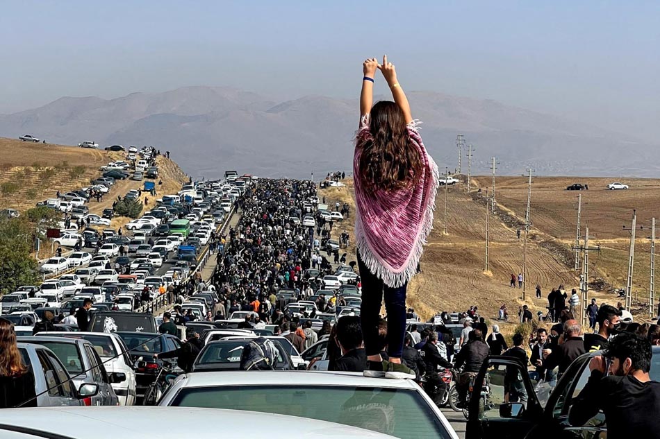 This UGC image posted on Twitter reportedly on Wednesday shows an unveiled woman standing on top of a vehicle as thousands make their way towards Aichi cemetery in Saqez, Mahsa Amini's home town in the western Iranian province of Kurdistan, to mark 40 days since her death, defying heightened security measures as part of a bloody crackdown on women-led protests. A wave of unrest has rocked Iran since 22-year-old Amini died on Sept. 16 following her arrest by the morality police in Tehran for allegedly breaching the country's strict rules on hijab headscarves and modest clothing. UGC, AFP
