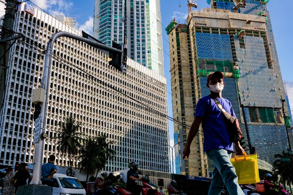 Pedestrians cross an intersection in the Makati Business District on October 6, 2022. The Philippine Statistics Authority said around 2.68 million Filipinos were jobless in August as the unemployment rate climbed to 5.3 percent from 5.2 percent in July. George Calvelo, ABS-CBN News/FILE