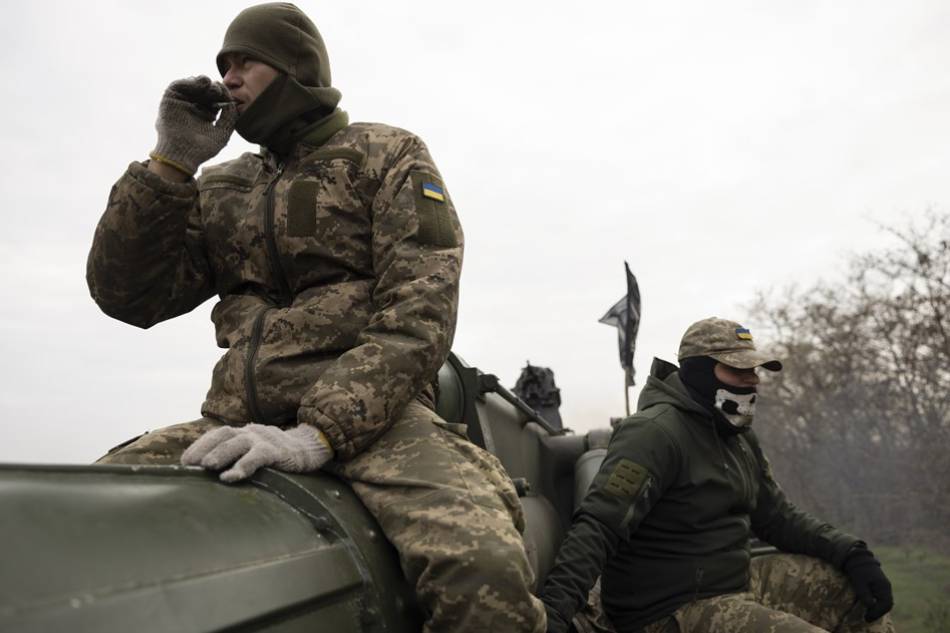 Ukrainian servicemen rest on a self-propelled 203mm cannon 'Pion' on their position in Kherson area, Ukraine, on Nov. 9, 2022 amid the Russian invasion. Stanislav Kozliuk, EPA-EFE/File