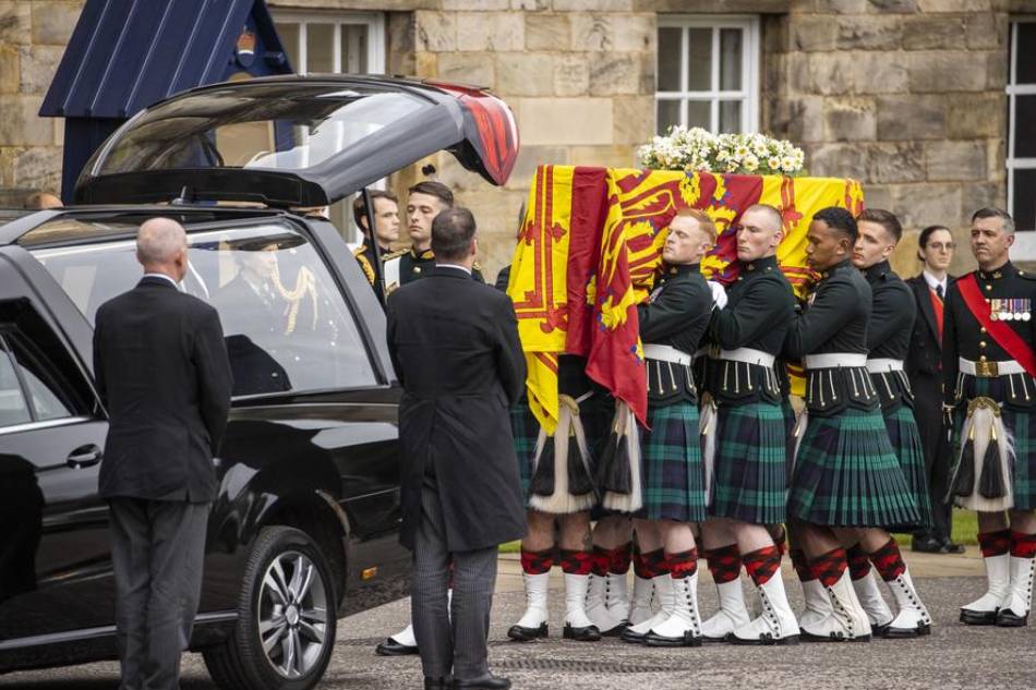 A handout photo made available by the British Army showing the bearer party with HM Queen Elizabeth II coffin, at the Palace of Holyrood, in Edinburgh, Scotland, Britain, Sept. 11, 2022. The arrival of the hearse carrying Queen Elizabeth II marks the first stage of the journey from Balmoral to London. It will remain in Holyroodhouse overnight. Britain's Queen Elizabeth II died at her Scottish estate on Sept. 8, 2022. Corporal Nathan GM Tanuku, RLC/British Army handout/EPA-EFE 