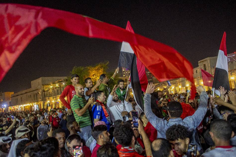 Fans of Morocco celebrate after Morocco won the FIFA World Cup 2022 Round of 16 match against Spain, at the Souq Waqif market in Doha, Qatar, 06 December 2022. Martin Divisek, EPA-EFE.