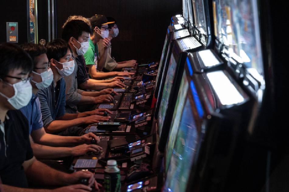 This photo taken on September 23, 2022 shows people playing video games at the GiGO Akihabara Building number 4, previously known as the Sega Akihabara Building number 4, which was filled with floors of arcade and video games, in the popular electronics shopping area of Akihabara in Tokyo. With the arcade industry struggling with fewer visitors due to Covid-19 and a trend to online gaming, the arcade - located directly opposite the train station - closed its doors on September 25 after the lease expired. Richard A. Brooks / AFP
