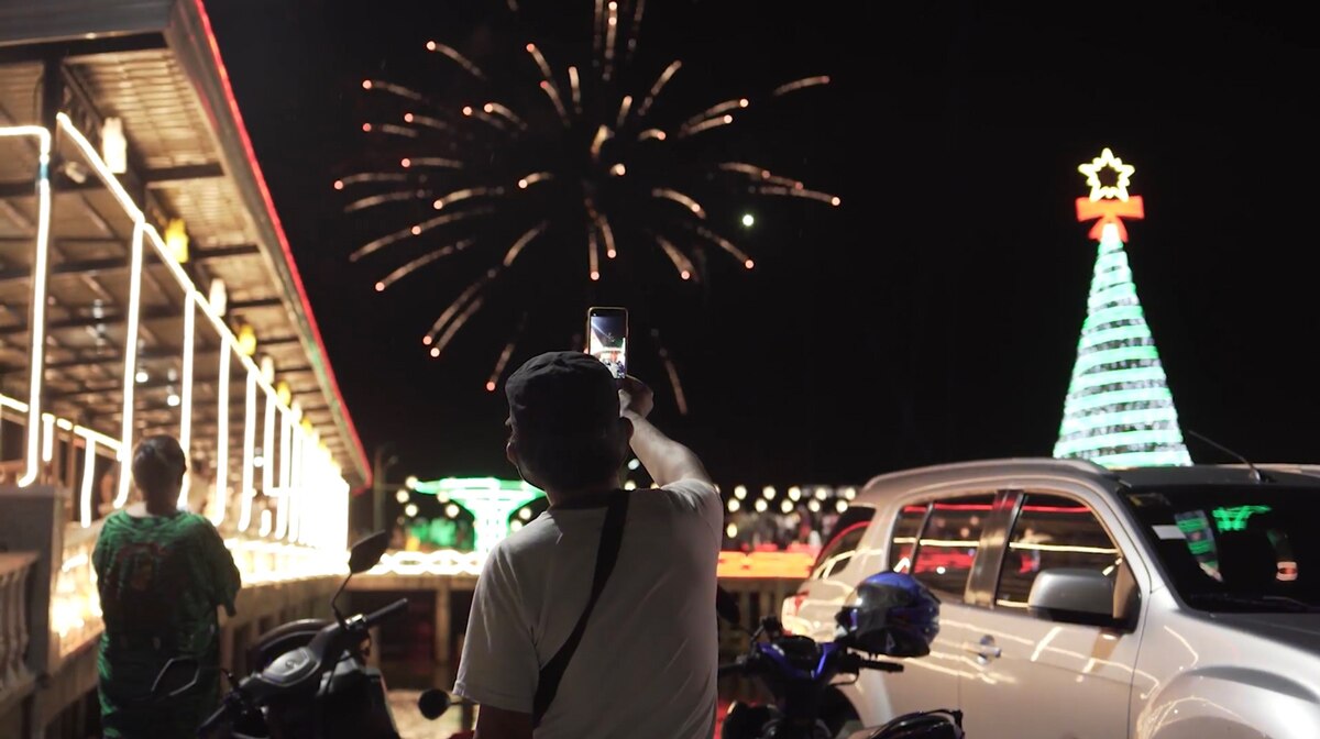 A man takes a photo of fireworks during the 2023 New Year's revelries in Cagayan de Oro City. Photo screenshot source: NESCAFÉ