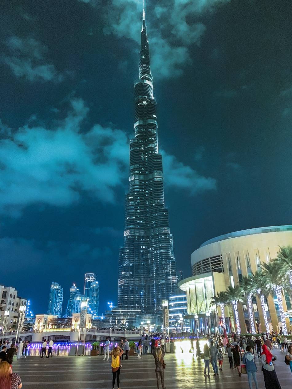 Photo source: Pexels [LINK OUT “Pexels”: https://www.pexels.com/photo/people-standing-near-high-rise-building-during-night-time-1707310/