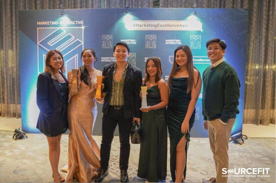 Sourcefit's marketing team holding their Marketing Excellence Award trophies. Photo source: Sourcefit