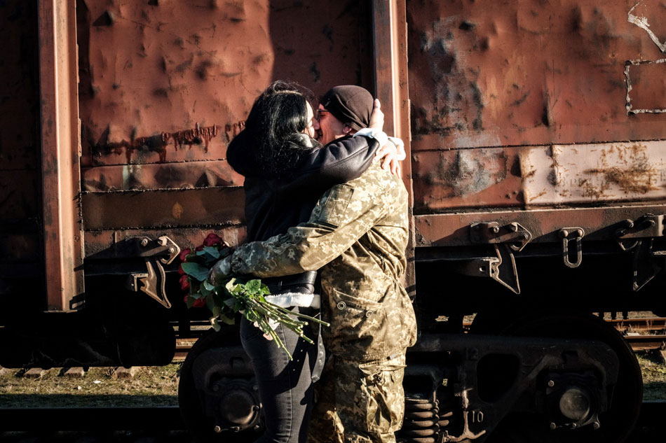 A Ukrainian serviceman embraces his partner upon her arrival from Kyiv at Kramatorsk train station on Jan. 27, 2023, amid the Russian invasion of Ukraine. Yasuyoshi Chiba, AFP