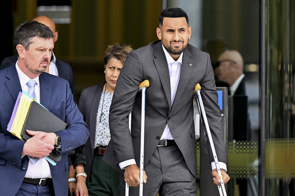Australian tennis player Nick Kyrgios (R) leaves the magistrate's court in Canberra. Saeed Khan, AFP