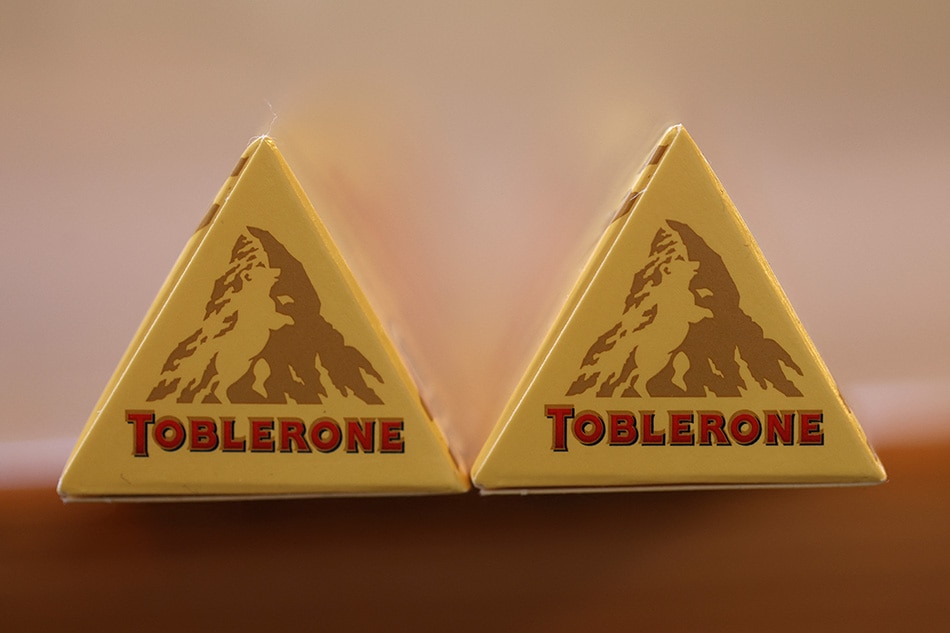 In this photo illustration, a Toblerone chocolate bar is displayed on March 07, 2023 in San Anselmo, California. Toblerone will drop the image of the Matterhorn Mountain from their packaging over rules in the “Swissness” legislation of 2017 that requires businesses to show how their products are sufficiently “Swiss” in order to use national symbols of Switzerland. (Photo Illustration by Justin Sullivan/Getty Images)  JUSTIN SULLIVAN / GETTY IMAGES NORTH AMERICA / Getty Images via AFP