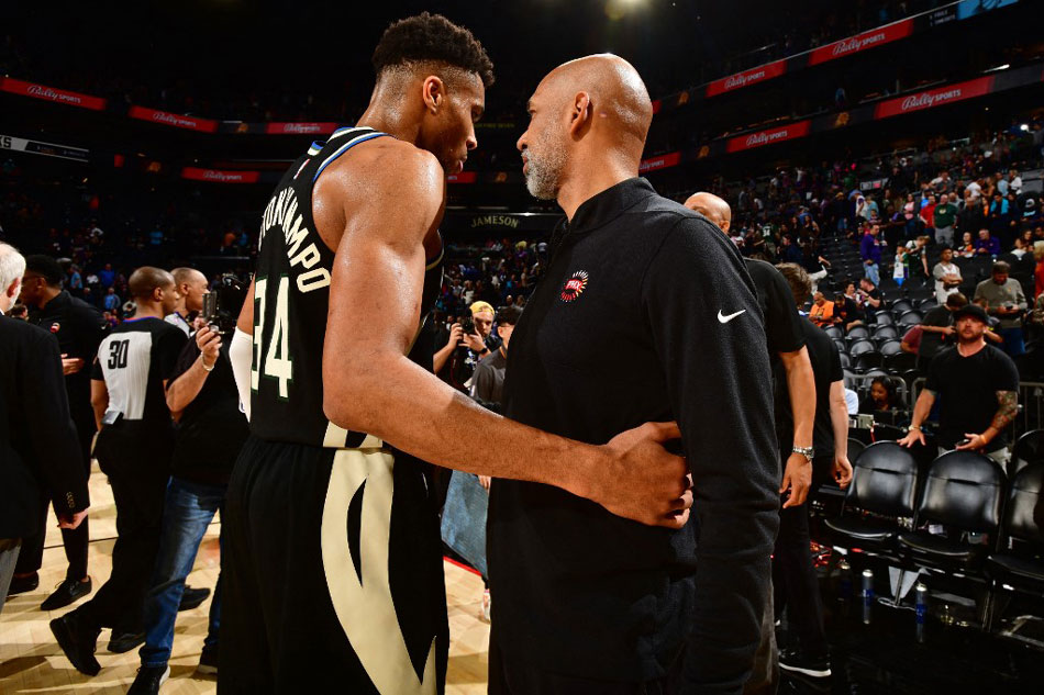 Giannis Antetokounmpo of the Milwaukee Bucks and Monty Williams of the Phoenix Suns greet each other after the game at Footprint Center in Phoenix, Arizona. Barry Gossage, NBAE via Getty Images/AFP