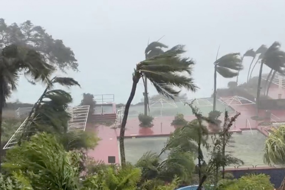 This video grab from the Twitter page of James Reynolds @EarthUncutTV shows tropical storm force winds blowing across Tumon Bay, Guam on May 24, 2023. Typhoon Mawar packing potentially catastrophic winds was heading for a direct hit on Guam on Wednesday May 24, a US territory in the Pacific that is a crucial American military outpost. A National Weather Service (NWS) report said Mawar's top winds had weakened slightly but remained a dangerous Category Four typhoon with maximum sustained winds of 140 miles (225 kilometers) per hour, and gusts up to 175 mph at landfall. James Reynolds, AFP