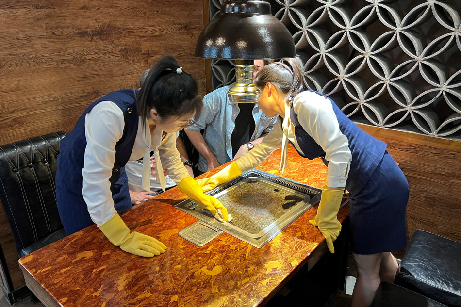 This picture taken on October 4, 2023 shows staff preparing a table for patrons at a North Korean restaurant in Beijing. South Koreans hoping to get a taste of authentic North Korean cuisine abroad maybe all out of luck, with Pyongyang-run restaurants across northern China saying they will refuse to serve their capitalist compatriots. Mladen Antonov,AFP