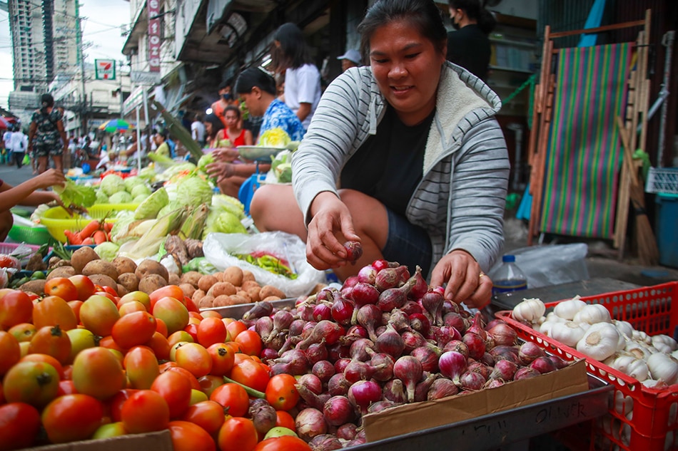 Vegetable venodr Len-len sells red onions at the Paco Market in Manila on December 28, 2022. Red Onion prices have reached as high as P600 a kilo. Jonathan Cellona, ABS-CBN News