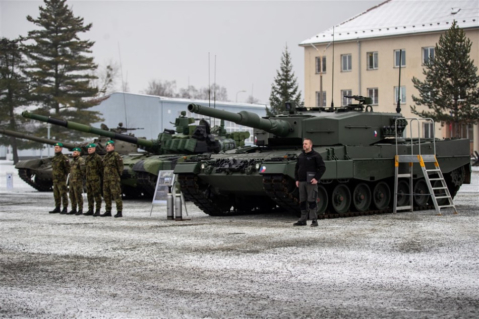 Czech soldiers stand near a Leopard 2A4 tank during a ceremony for the hand over of the symbolic key of the tank to the Czech army, in Praslavice, Czech Republic, 21 December 2022. EPA-EFE/VLADIMIR PRYCEK