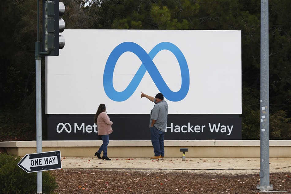 People stand in front of a Meta sign at the headquarters of Meta Platforms Inc., formerly named Facebook, Inc., in Menlo Park, California, USA, 08 November 2022. John Mabanglo, EPA-EFE