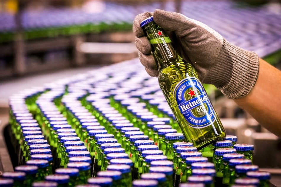 Heineken beer bottles of the alcohol free beer brand Heineken 0.0 on the conveyor belt during the production in Den Bosch, The Netherlands. Lex Van Lieshout/EPA-EFE