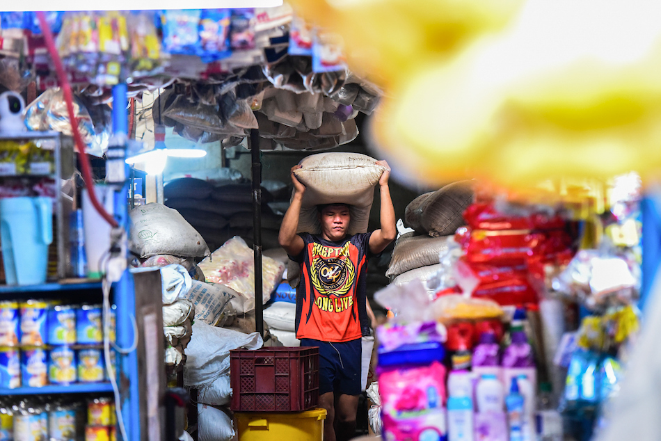 Workers stack sacks of locally produced sugar at a sugar retailer at the Marikina Public Market in Marikina City on May 16, 2023. Maria Tan, ABS-CBN News