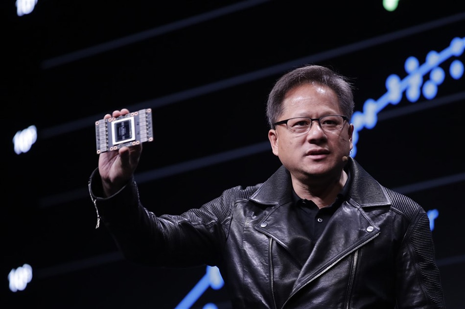 Nvidia president and CEO Jensen Huang displays a Tensor core GPU during the Annual GPU Technology conference in Taipei, Taiwan, 30 May 2018. Huang discussed Advance computing, Artificial intelligence and new GPU units during the conference. EPA-EFE/RITCHIE B. TONGO/FILE