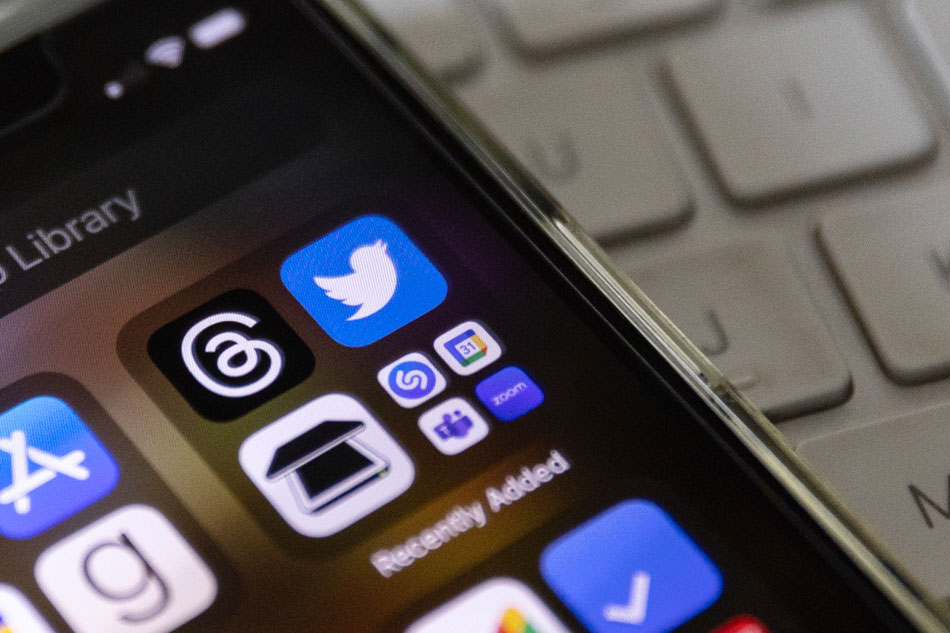 An illustration picture shows a mobile phone displaying the two icons of social media apps 