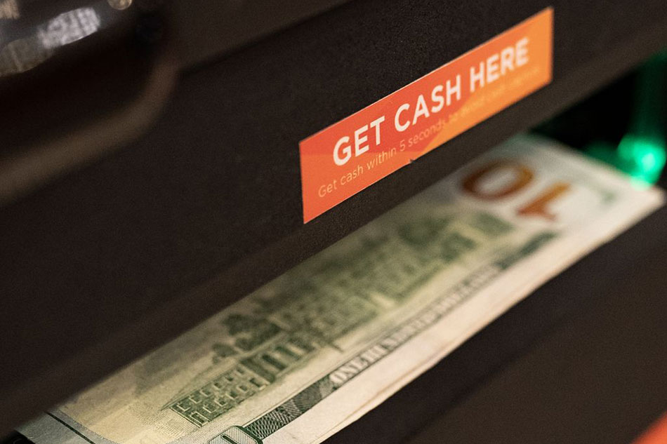 A UnionBank ATM dispenses dollars. Handout 