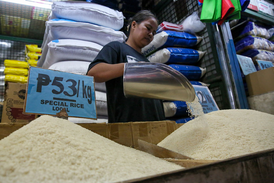 Vendors tend to their stalls selling rice at the Kamuning Market in Quezon City on August 9, 2023. Jonathan Cellona, ABS-CBN News