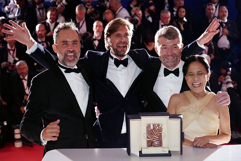 Ruben Östlund (second from left), winner of the Palme d'or Prize for 'Triangle of Sadness' poses with Erik Hemmendorff, Dolly De Leon, Philippe Bober during the Award Winners' photocall at the 75th annual Cannes Film Festival, in Cannes, France, 28 May 2022. Clemens Bilan, EPA-EFE