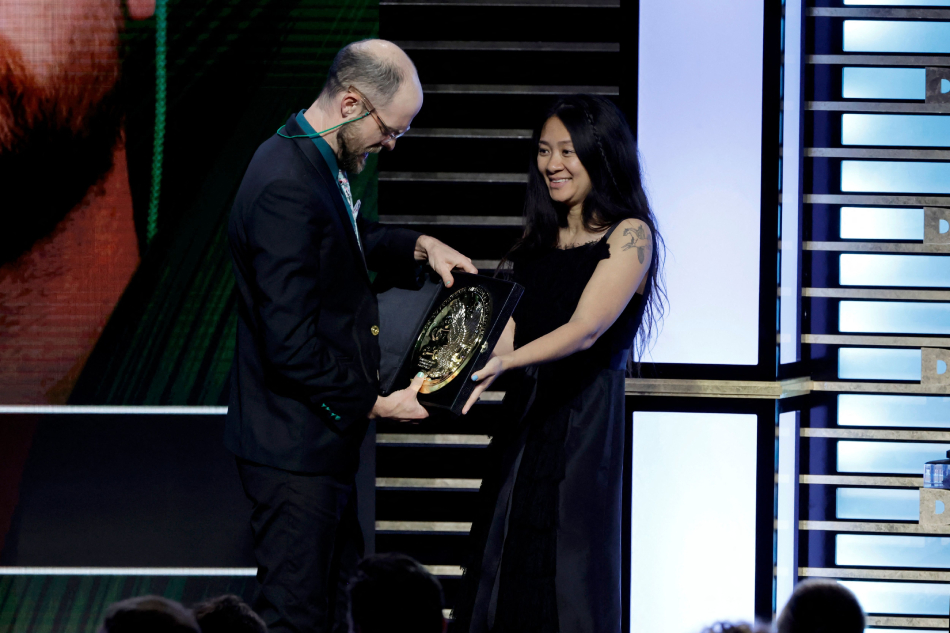 (L-R) Daniel Scheinert accepts the Outstanding Directorial Achievement in Theatrical Feature Film for 'Everything Everywhere All at Once' from Chloé Zhao onstage during the 75th Directors Guild of America Awards at The Beverly Hilton on February 18, 2023 in Beverly Hills, California. Kevin Winter, AFP