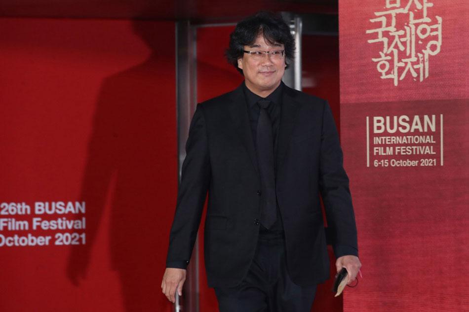  South Korean filmmaker Bong Joon-ho walks on the red carpet at the opening ceremony of the 26th Busan International Film Festival in this October 2021 file photo. Yonhap, EPA-EFE