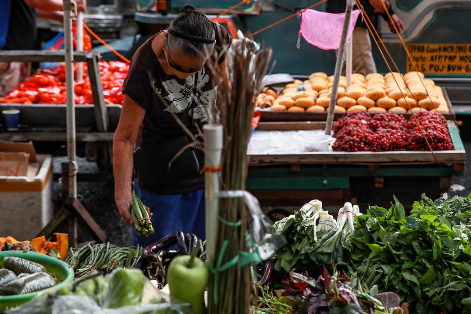 Vegetable vendors attend to their customers in Guadalupe Market in Makati City on January 13, 2023. Jonathan Cellona, ABS-CBN News