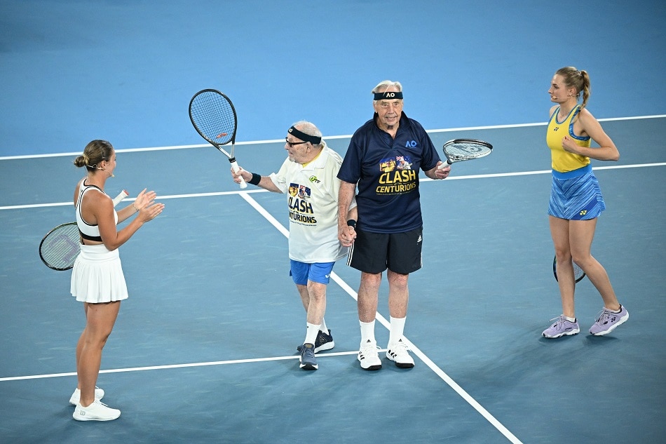 Centenarian tennis players Leonid Stanislavsky (2nd left) and Henry Young (2nd right) arrive on the court during the Tennis Plays for Peace charity event at Rod Laver Arena in Melbourne, Australia, on 11 January 2023. EPA-EFE/JAMES ROSS