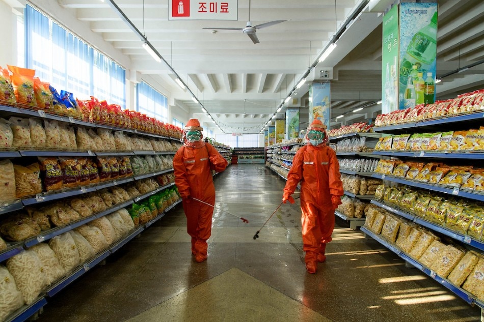  Employees spray disinfectant as part of preventative measures against COVID-19 at the Yokjon Department Store in Pyongyang on Oct. 20, 2021. Kim Won Jin, AFP/File 