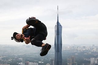 Jumpers in action in Kuala Lumpur Base jump event