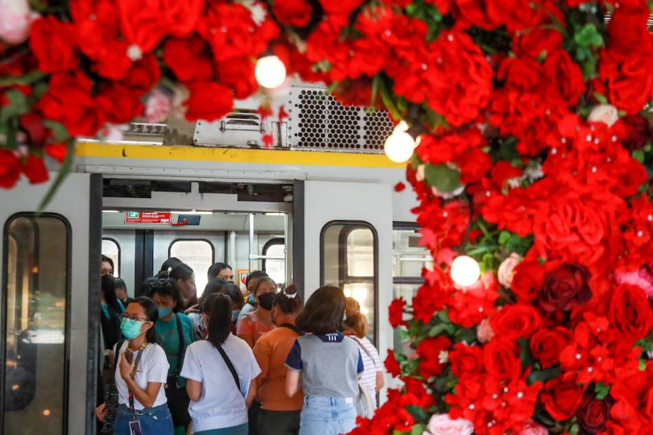 Passengers walk past a Valentine’s Day installation at LRT-1 Central Station in Manila on February 13, 2023. Jonathan Cellona, ABS-CBN News