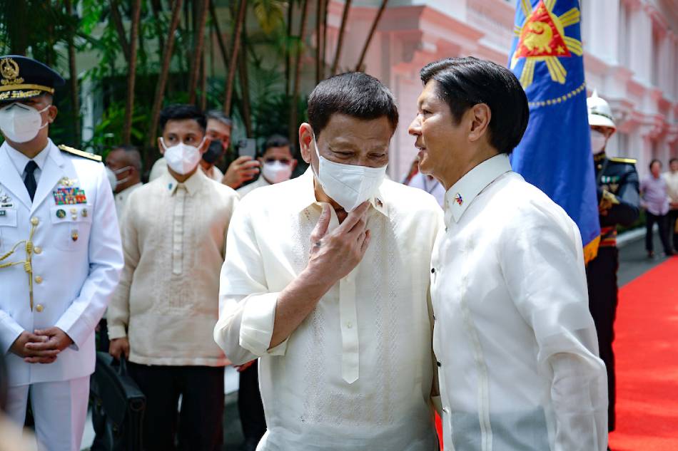 Former President Rodrigo Duterte listens to successor President Ferdinand Marcos, Jr. after the departure honors at the Malacanang Palace on June 30, 2022. File/King Rodriguez, Presidential Photo