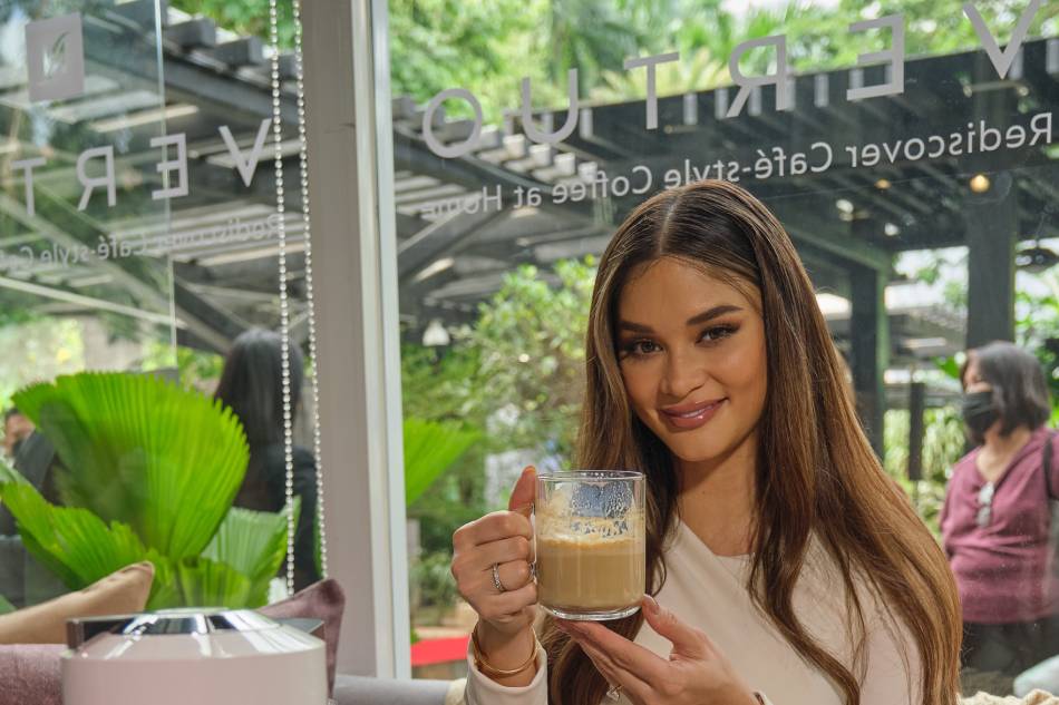 Pia Wurtzbach holds a cup of coffee during the launch of Nespresso Vertuo. Handout