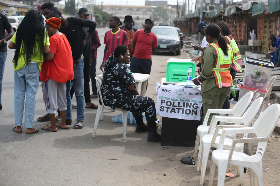A security personnel watches the electoral officers after the vote count at a polling station during the general elections, in the Ikeja district of Lagos, Nigeria, 25 February 2023. Akintunde Akinleye, EPA-EFE.