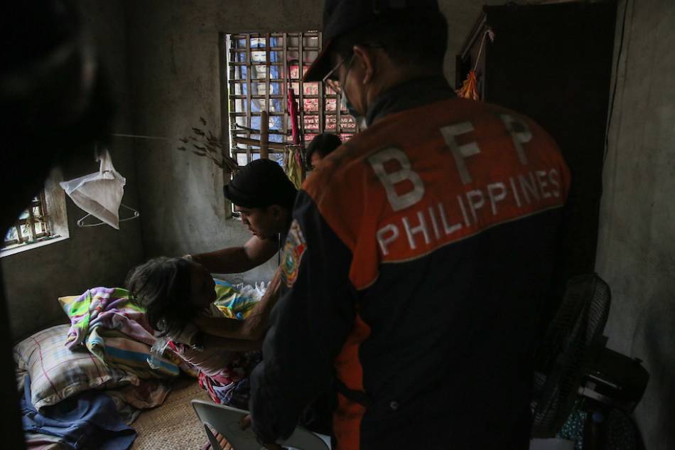 Medical teams and members of the Bureau of Fire Protection check on a bedridden elderly woman in Agoncillo, Batangas on Jan. 14, 2020 as Taal Volcano threatened to erupt. Jonathan Cellona, ABS-CBN News