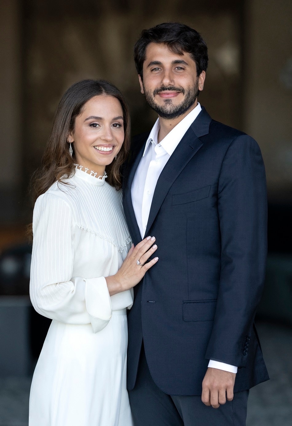 A handout picture released by Jordanian Royal Palace shows Princess Iman, the daughter of King Abdullah II of Jordan, with her fiance Jameel Alexander Thermiotis during their engagement ceremony in Amman on July 5, 2022. The Royal Hashemite Court announced the engagement of the princess to Thermiotis who was born in 1994 in Venezuela to a family of Greek origin and currently works in the field of finance in New York. Jordanian Royal Palace / AFP