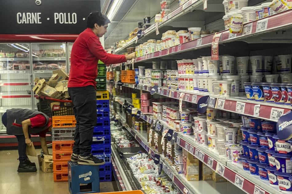 Employees of a supermarket organize products on the shelves, in Buenos Aires, Argentina, 14 March 2023. Consumer prices in Argentina experienced a year-on-year rise of 102.5 percent last February, 3.7 percentage points more than last January, the National Institute of Statistics and Censuses (Indec) reported on 14 March. In the second month of the year, consumer prices grew 6.6 percent compared to last January, evidencing an acceleration with respect to the rate of 6 percent of the previous month. EPA-EFE/Juan Ignacio Roncoroni