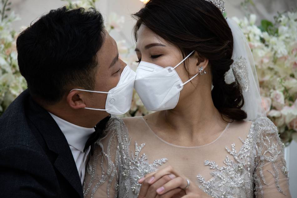 South Korean groom Chang Seung-yun (L) and his Vietnamese bride Nguyen Thi Ut (R) pose a kiss during a wedding ceremony amid the coronavirus pandemic in Seoul, South Korea, Oct. 25, 2020. Jeon Heon-Kyun, EPA-EFE