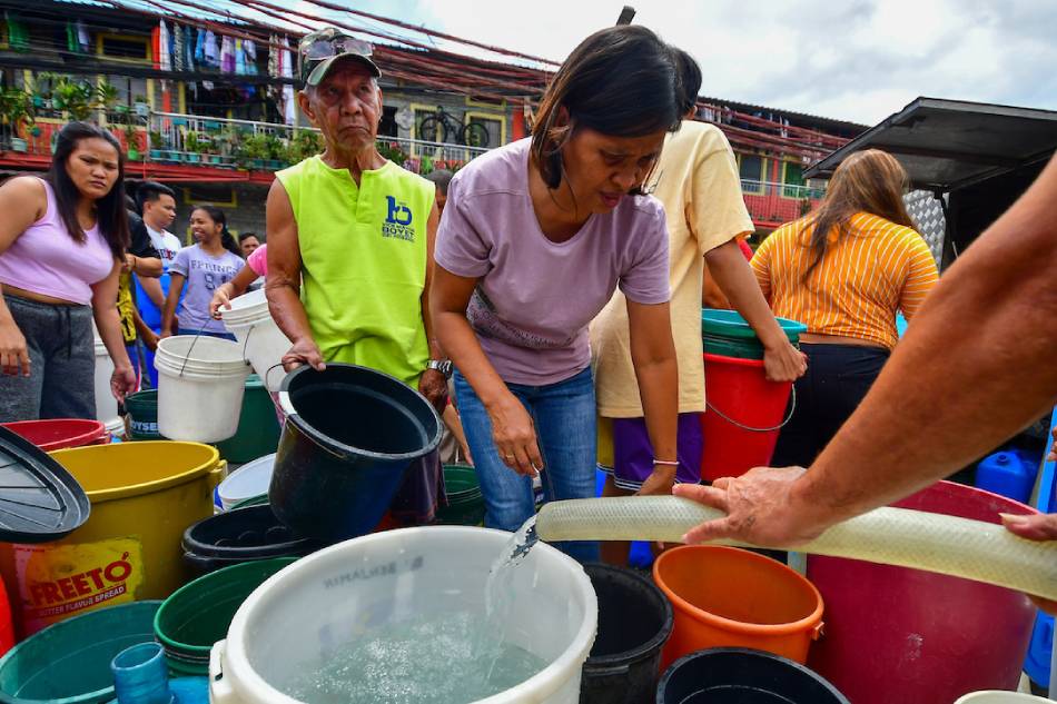 Residents of Barangay 165 in Pasay City stock up on delivered water from a mobile tanker on March 5, 2023. Mark Demayo, ABS-CBN News 