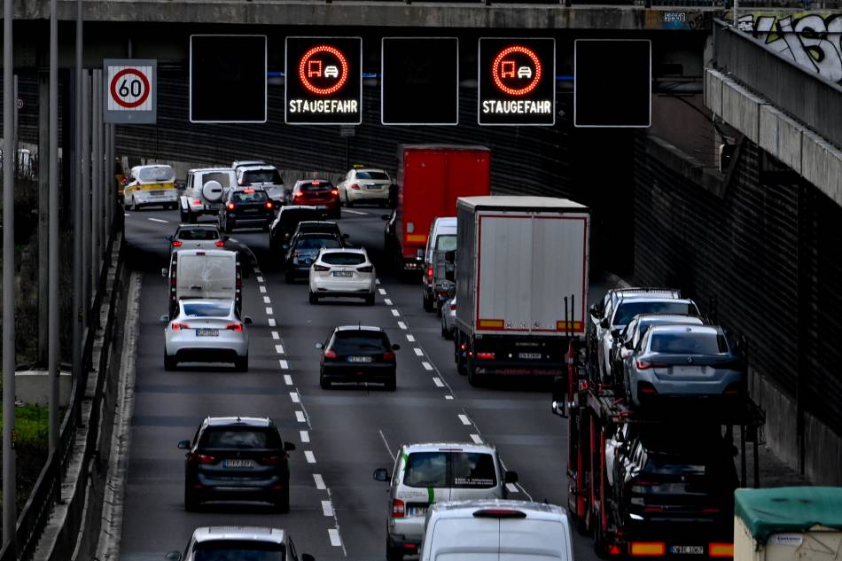 Traffic signs inform drivers for 'Risk of traffic jams' during heavy traffic on Berlin's A100 motoway amid a nationwide transportation warning strike in Germany, March 27, 2023. German unions are calling on thousands of workers across the country's transport system to stage a one-day warning strike that is expected to bring widespread disruption to planes, trains and local transit. Filip Singer, EPA-EFE.