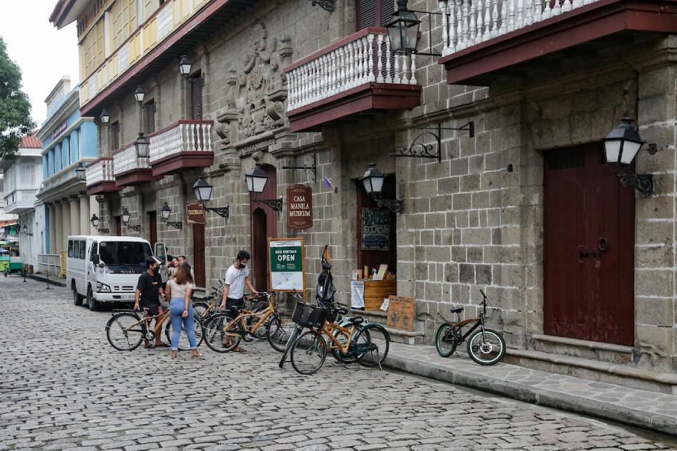People visit a bike rental shop inside Intramuros in Manila. 📷: George Calvelo, ABS-CBN News