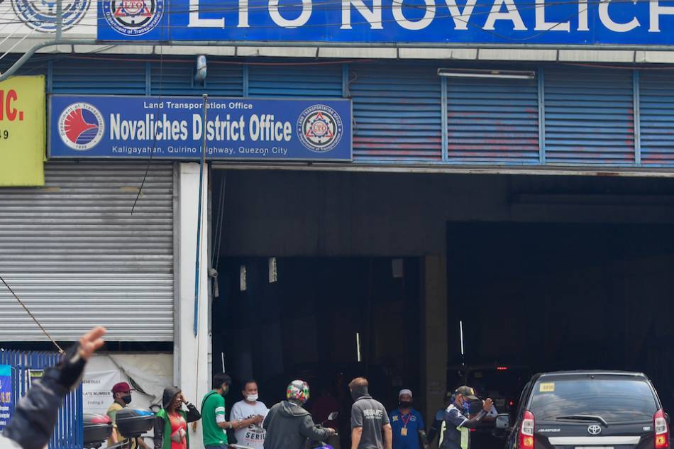 Motorists line up at the Land Transportation Office's Novaliches office in Quezon City on July 14, 2020, mostly for license and car registration and renewal. LTO gave a 60-day grace period where late penalties are waived. Mark Demayo, ABS-CBN News